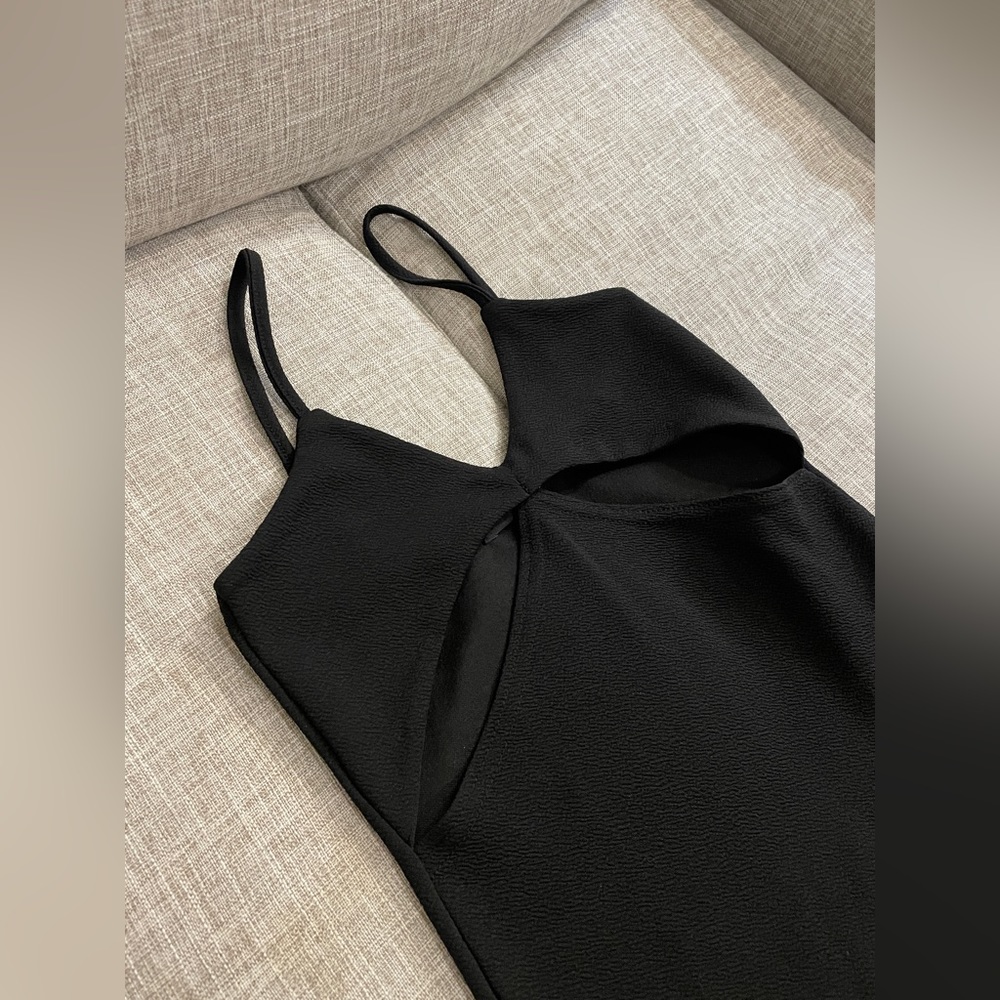 Midi dress black has a slight opening in the bottom